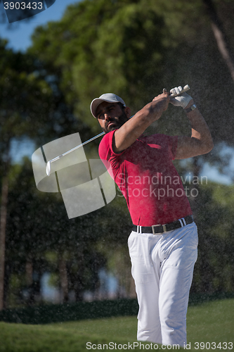 Image of golfer hitting a sand bunker shot