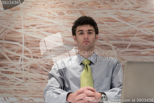 Image of young business man  working on laptop  computer at modern office