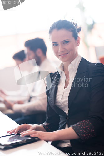 Image of business woman on meeting  using tablet