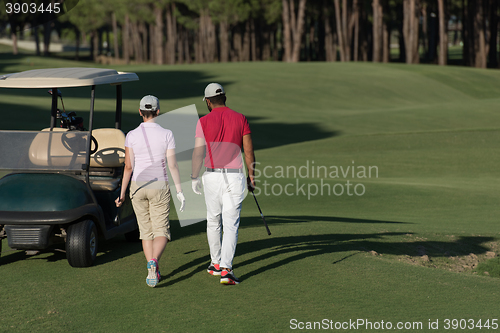 Image of couple walking on golf course