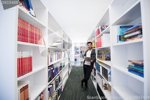 Image of student with tablet in library