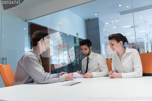 Image of young couple signing contract documents on partners back