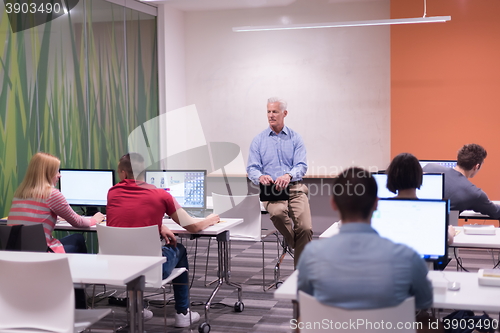 Image of teacher and students in computer lab classroom