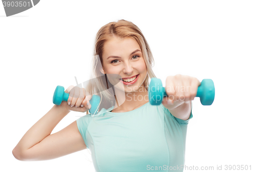 Image of smiling beautiful young sporty woman with dumbbell