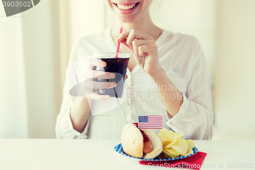 Image of close up of happy woman drinking cola