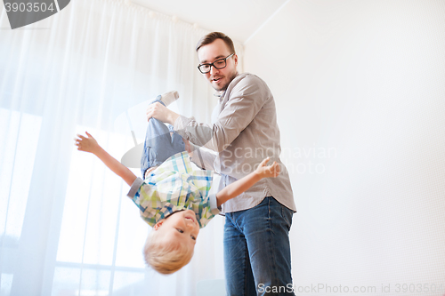 Image of father with son playing and having fun at home