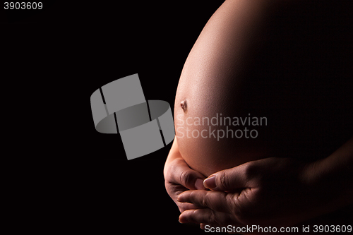 Image of Pregnant woman silhouette over black background