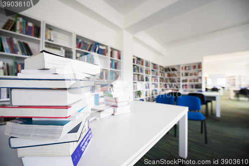 Image of female student study in library, using tablet and searching for 