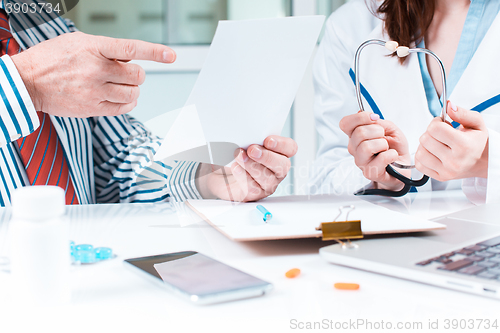 Image of The patient and his doctor in medical office