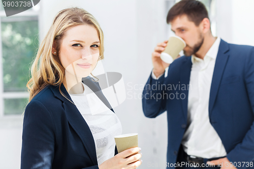 Image of Young colleagues having coffee break in office