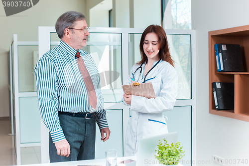 Image of patient smiling to his doctor in medical office