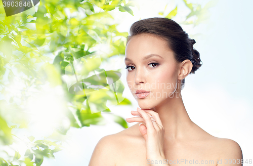 Image of face of beautiful asian woman with golden ring