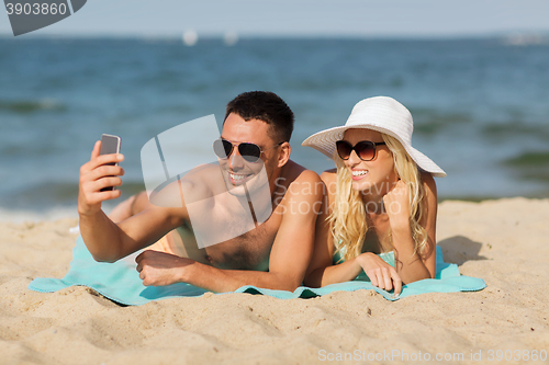 Image of happy couple in swimwear walking on summer beach