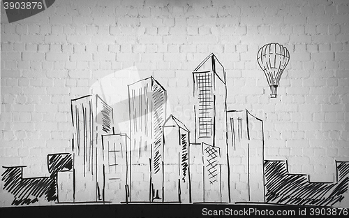 Image of drawing of city over brick wall background