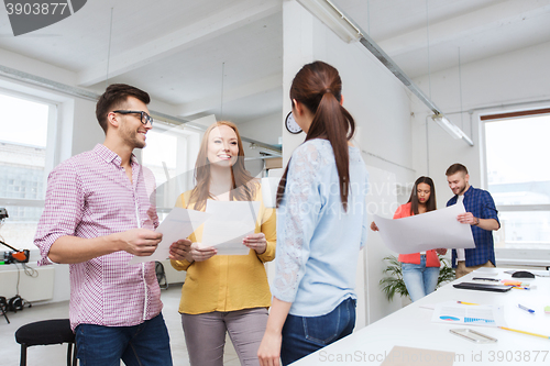 Image of creative team on coffee break talking at office