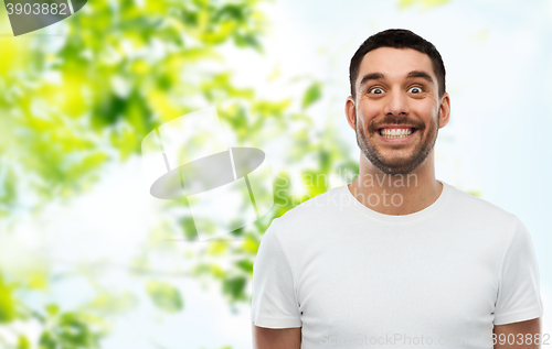 Image of man with funny face over green natural background