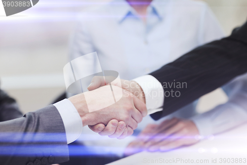 Image of two businessmen shaking hands in office