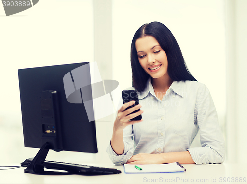Image of smiling businesswoman or student with smartphone