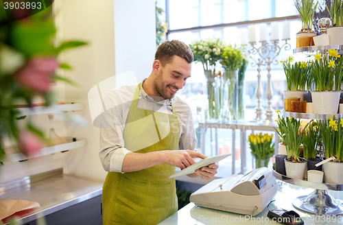 Image of man with tablet pc computer at flower shop