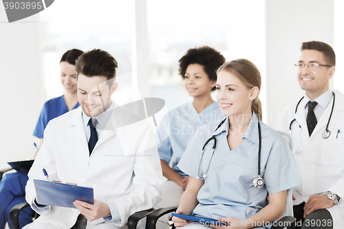 Image of group of happy doctors on seminar at hospital