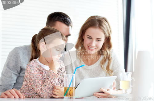 Image of happy family with tablet pc at restaurant