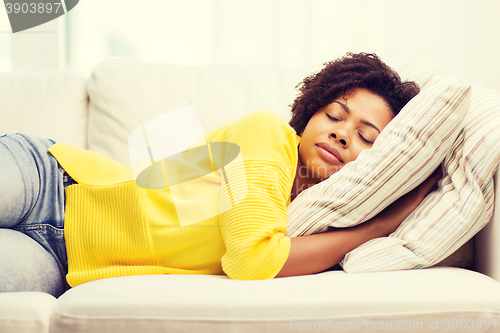 Image of african young woman sleeping on sofa at home