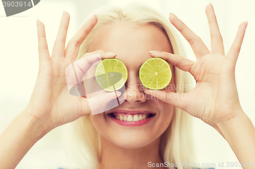 Image of happy woman having fun covering eyes with lime
