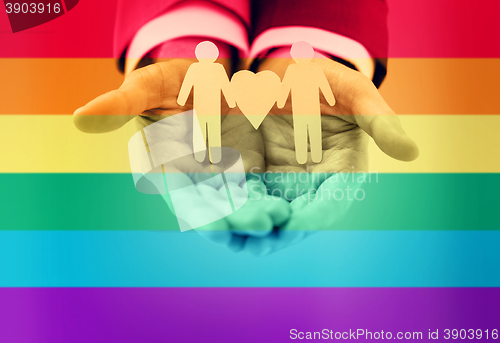 Image of close up of happy male gay couple with love symbol