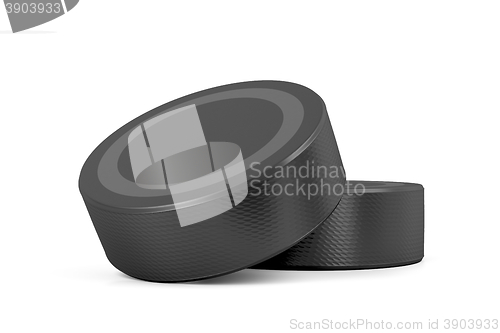 Image of Two ice hockey pucks