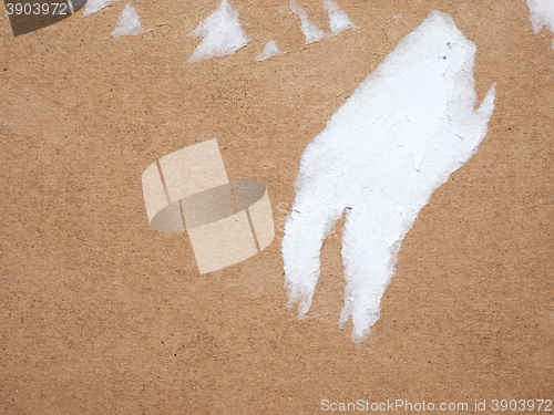 Image of Brown corrugated cardboard background with ripped label