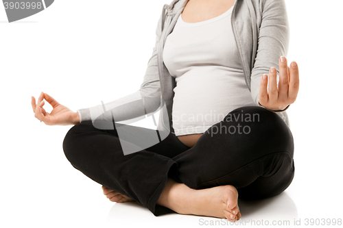 Image of Pregnant woman relax doing yoga over white