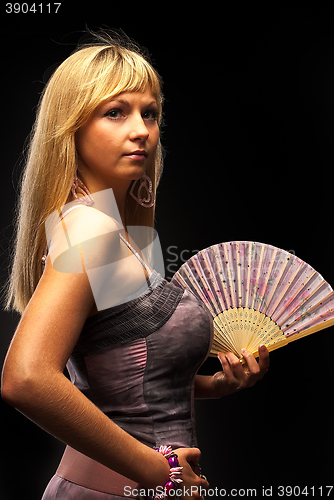 Image of Beautiful young woman with fan