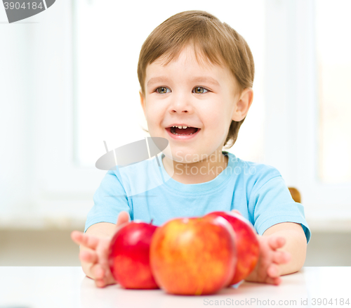 Image of Portrait of a happy little boy with apples