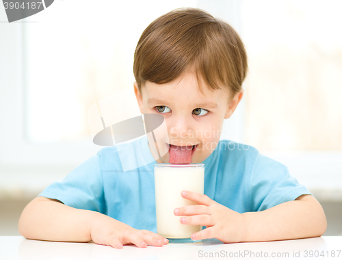 Image of Cute little boy with a glass of milk