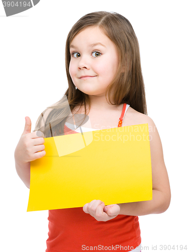 Image of Little girl is holding blank yellow banner