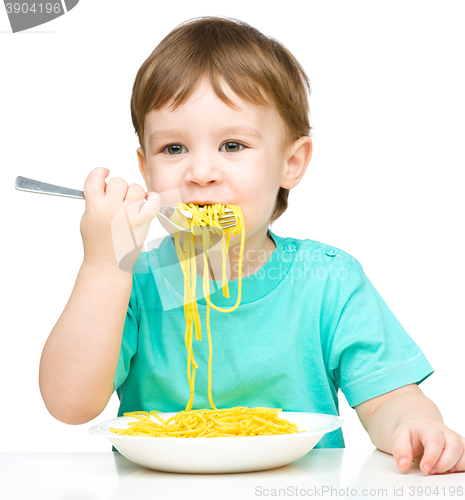 Image of Little boy is eating spaghetti