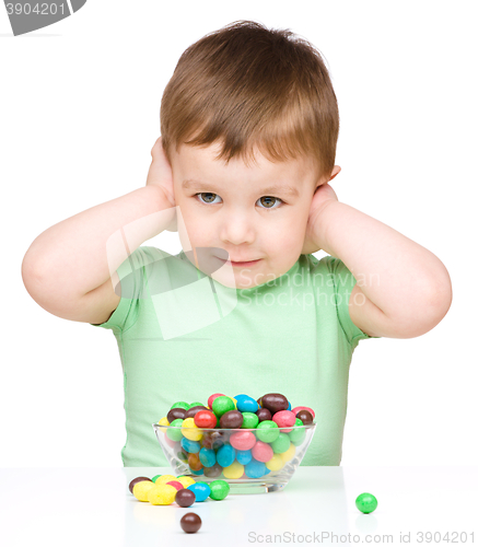 Image of Portrait of a boy with candies