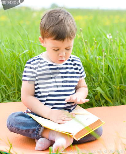 Image of Little boy is reading book