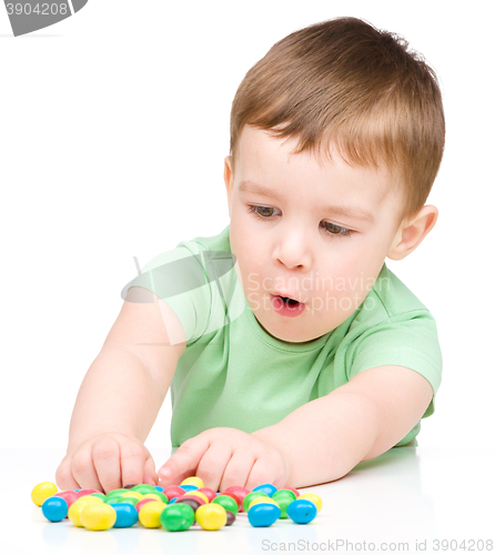 Image of Portrait of a boy with candies