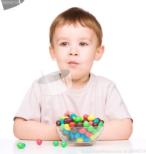 Image of Portrait of a boy with candies