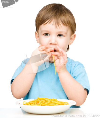 Image of Little boy is eating spaghetti