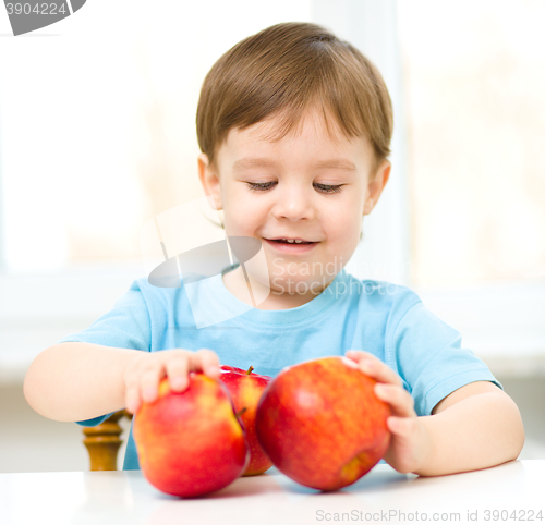 Image of Portrait of a happy little boy with apples