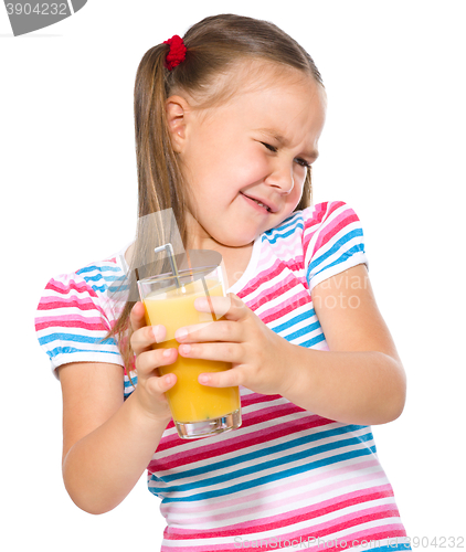 Image of Little girl unwillingly drinking orange juice