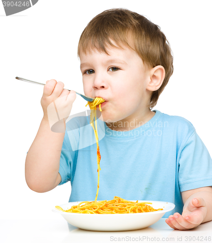 Image of Little boy is eating spaghetti
