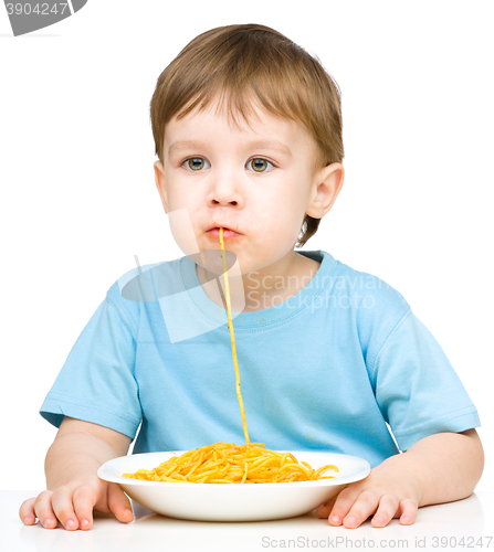 Image of Little boy is eating spaghetti