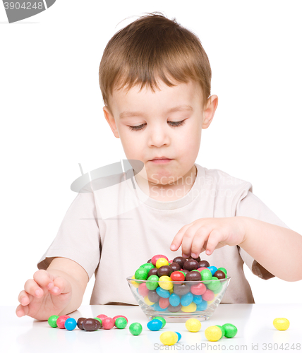 Image of Portrait of a boy with candies