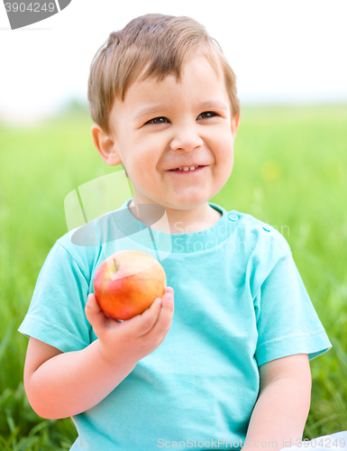 Image of Portrait of a happy little boy with apple