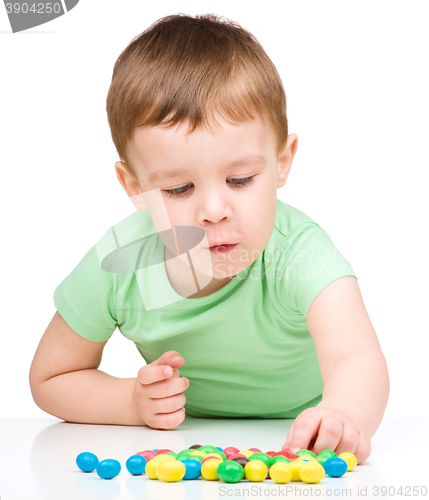Image of Portrait of a boy with candies