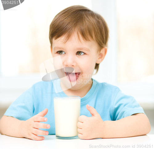 Image of Cute little boy with a glass of milk