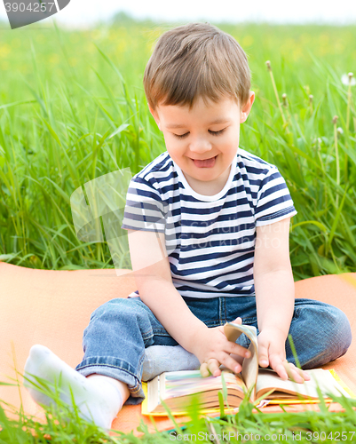 Image of Little boy is reading book